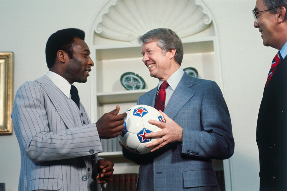Pelé gives a soccer ball to US President Jimmy Carter during a White House visit on March 28, 1977.