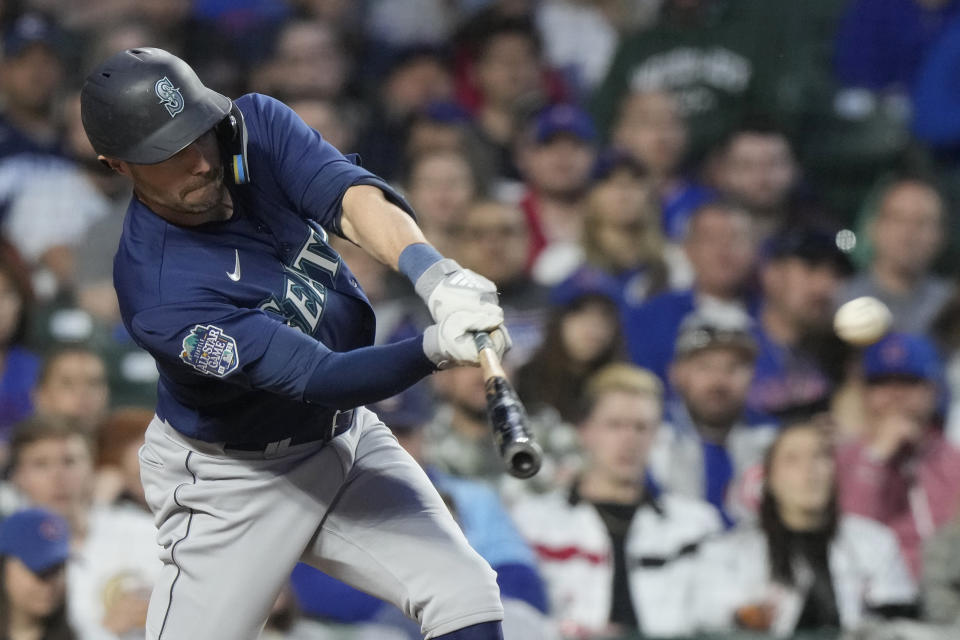 Seattle Mariners' AJ Pollock hits a sacrifice fly to Chicago Cubs left fielder Ian Happ during the fourth inning of a baseball game in Chicago, Monday, April 10, 2023. (AP Photo/Nam Y. Huh)