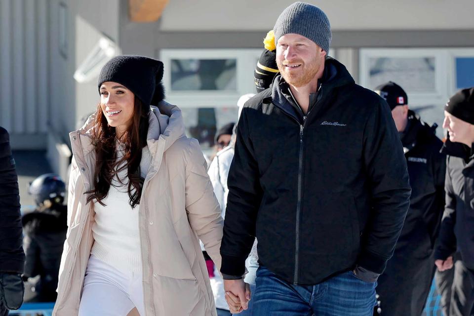<p>Andrew Chin/Getty </p> Meghan Markle (left) and Prince Harry attend the Invictus Games Winter Training Camp on Feb. 14, 2024