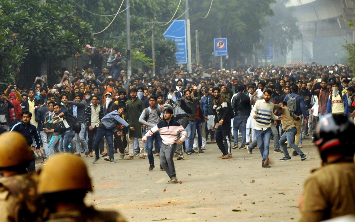 Students outside the Jamia Millia Islamia University during a protest against the Citizenship Amendment Bill, in Delhi - AP