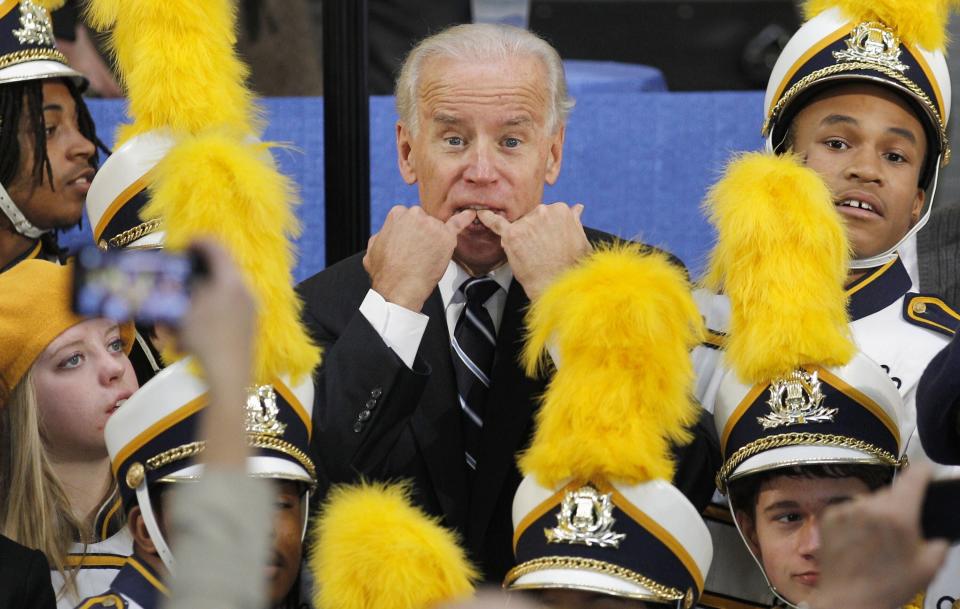 Standing amid members of the Euclid High School marching Band, Vice-President Joe Biden whistles to get someone's attention following a campaign stop at a fire station in Euclid, Ohio, Tuesday, Nov. 15, 2011. (AP Photo/Amy Sancetta)