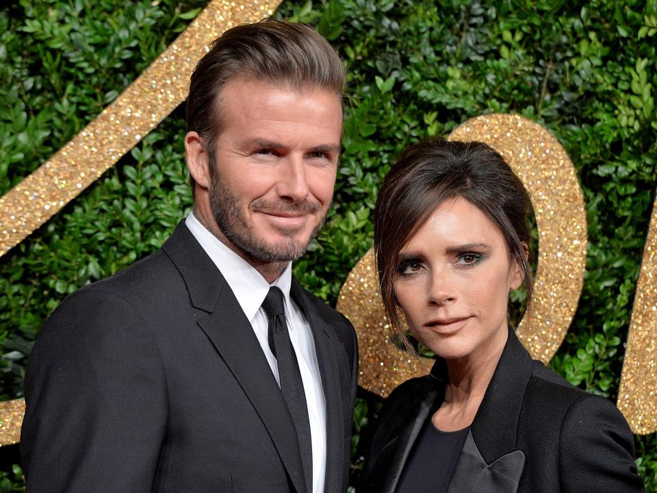 David and Victoria Beckham posing for a photo at an awards show.