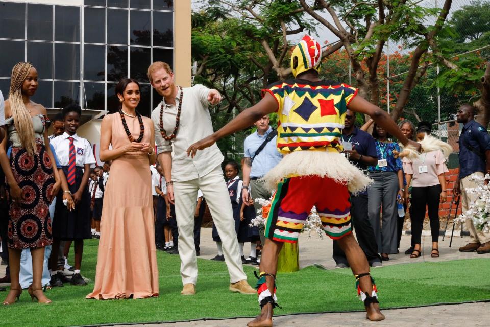 Prince Harry and Meghan Markle watch a performance at Lightway Academy in Nigeria in May 2024.