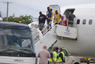 Haitians who were deported from the United States deplane at the Toussaint Louverture International Airport, in Port au Prince, Haiti, Sunday, Sep. 19, 2021. Thousands of Haitian migrants have been arriving to Del Rio, Texas, to ask for asylum in the U.S., as authorities begin to deported them to back to Haiti which is in a worse shape than when they left. (AP Photo/Joseph Odelyn)