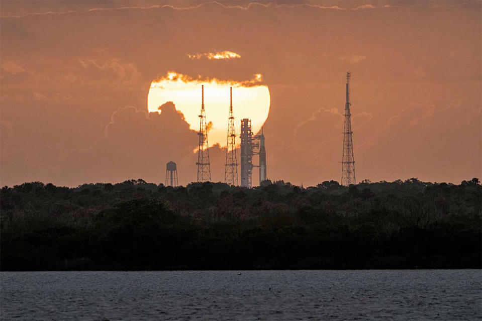 The sun rises behind the Space Launch System Artemis-1 rocket atop pad 39B at the Kennedy Space Center Thursday. NASA plans to carry out a dress rehearsal countdown and fueling test April 1-3 to clear the way for launch in the late May-early June timeframe. / Credit: NASA