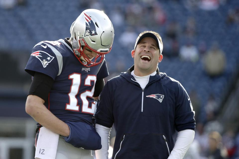 New England Patriots quarterback Tom Brady, left, shares a laugh with offensive coordinator Josh McDaniels before an NFL football game against the Miami Dolphins, Sunday, Dec. 29, 2019, in Foxborough, Mass.