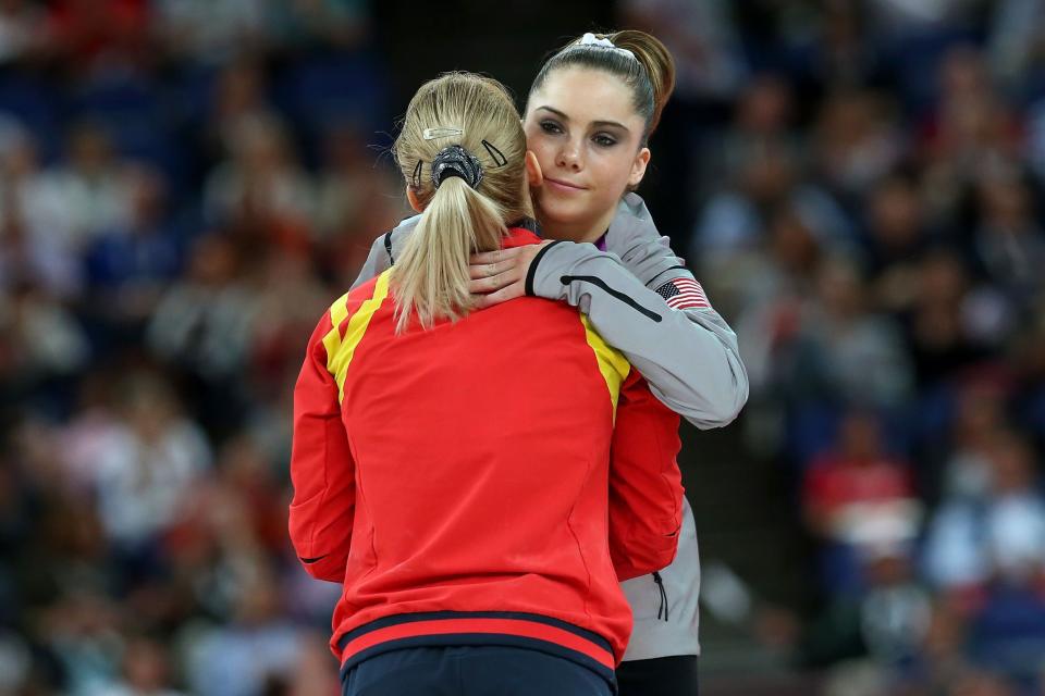 <p>Silver medalist McKayla Maroney Maroney (R) of the United States greets gold medalist Sandra Raluca Izbasa of Romania during the medal ceremony following the Artistic Gymnastics Women’s Vault final on Day 9 of the London 2012 Olympic Games at North Greenwich Arena on August 5, 2012 in London, England. (Photo by Ronald Martinez/Getty Images) </p>