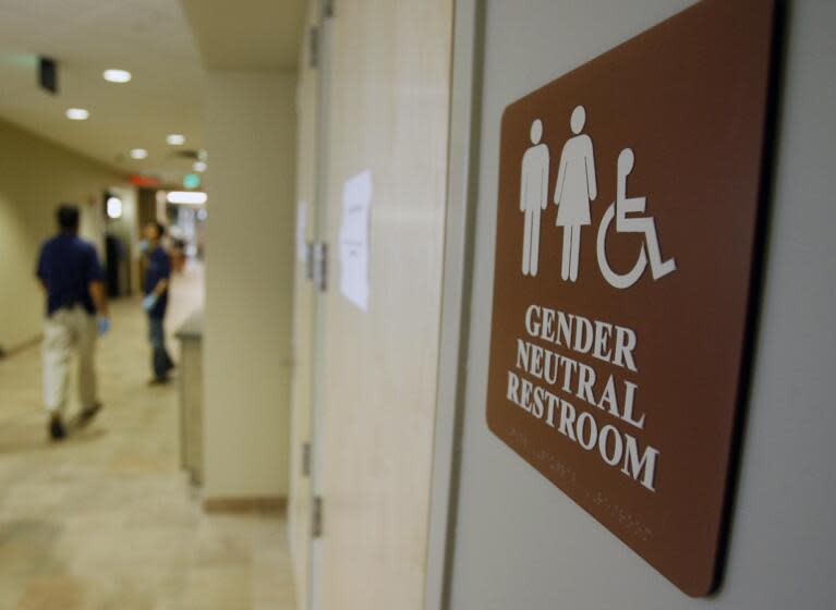 FILE - In this Aug. 23, 2007, file photo, a sign marks the entrance to a gender-neutral restroom at the University of Vermont in Burlington, Vt. The Montana Supreme Court has ordered the attorney general to rewrite ballot language for an initiative that would require people to use public restrooms designated for their gender at birth. The court ruled Tuesday, Sept. 19, 2017, in a challenge from the American Civil Liberties Union of Montana, saying the language didn't include the initiative's specific definition of "sex" and was otherwise vague. (AP Photo/Toby Talbot, File)