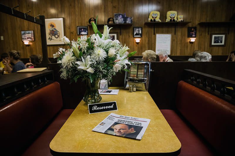 Flowers are seen on a booth at Holsten’s in New Jersey — where the final episode of “The Sopranos” took place — after the death of actor James Gandolfini in June 2013. (Photo by Andrew Burton/Getty Images)