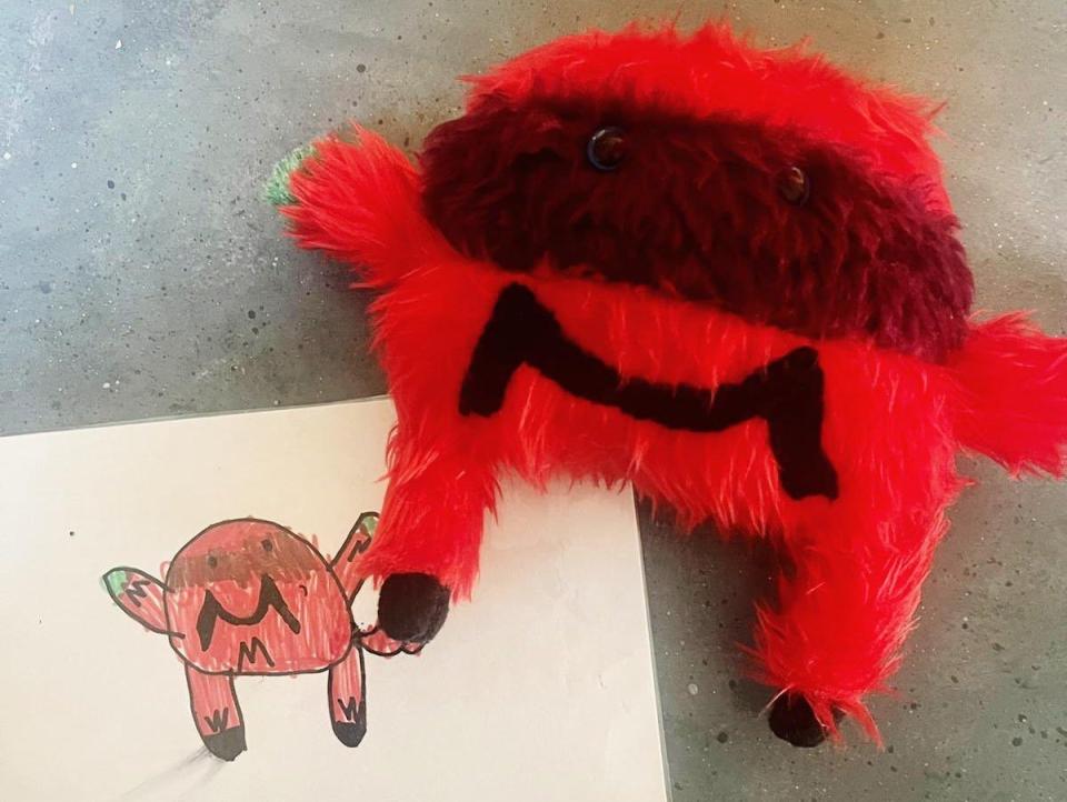 A drawing of a monster and the monster made into a toy that looks exactly like it