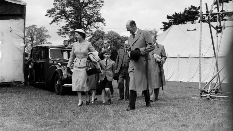 Queen Elizabeth II (1926-2022), Prince Charles and Henry Somerset, 10th Duke of Beaufort (1900-1984) first right, attend the Royal Windsor Horse Show, Berkshire, May 23rd 1956.