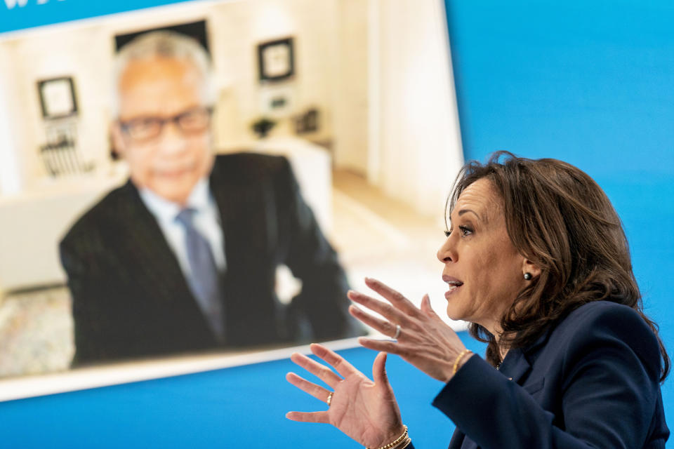 Dr. Reed Tuckson with the Black Coalition Against COVID, is displayed on a monitor behind Vice President Kamala Harris as she speaks during a virtual meeting with community leaders to discuss COVID-19 public education efforts in the South Court Auditorium in the Eisenhower Executive Office Building on the White House Campus, Thursday, April 1, 2021, in Washington. (AP Photo/Andrew Harnik)