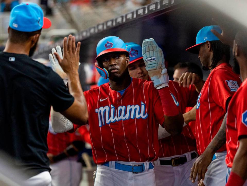 Miami Marlins right fielder Jesus Sanchez (7) celebrates with his teammates after scoring a run against the Chicago Cubs in the first inning of an MLB game at loanDepot park on Saturday, April 29, 2023, in Miami, Fla.