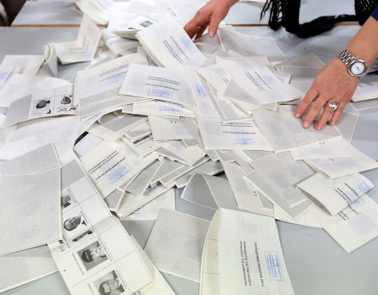 A handout picture released by the Cypriot Press and Information Office (PIO) shows ballots being sorted on February 17, 2013 in Nicosia, following the nationwide general elections. Rightwing leader Nicos Anastasiades and communist-backed Stavros Malas are to contest a runoff poll in economic crisis-hit Cyprus, final results of a presidential election on Sunday showed