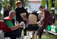 A man receives medical treatment after he was released from a detention centre in Minsk