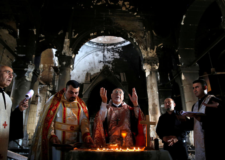 Iraqi priests hold the first Sunday mass at the Grand Immaculate Church