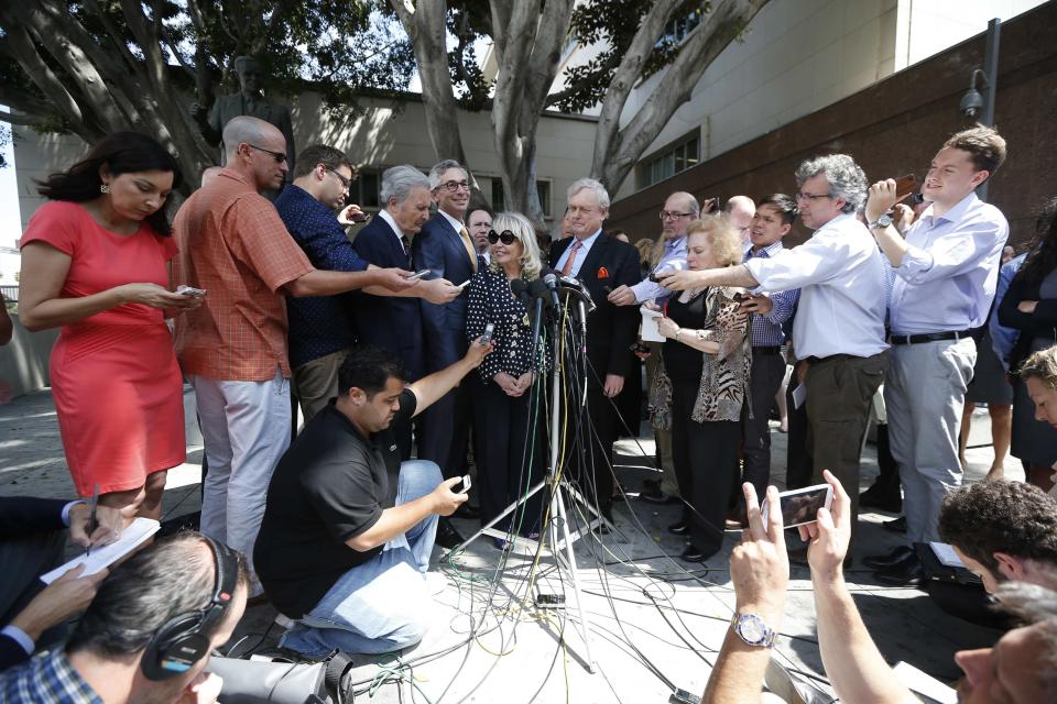 Shelly Sterling, 79, (C, at podium) speaks at a news conference with her lawyer Pierce O'Donnell (C-R) and Steve Ballmer's lawyer Adam Streisand (C-L) in Los Angeles, California July 28, 2014. The record $2 billion sale of pro basketball's Los Angeles Clippers to former Microsoft Corp chief executive Steve Ballmer can proceed over the objections of co-owner Donald Sterling, a judge tentatively ruled on Monday. Los Angeles Superior Court Judge Michael Levanas said the deal, brokered by Sterling's estranged wife, Shelly Sterling, was permissible and could be consummated even if Sterling, who has been banned for life from the NBA for racist remarks, chose to appeal. REUTERS/Lucy Nicholson (UNITED STATES - Tags: CRIME LAW SPORT BASKETBALL)