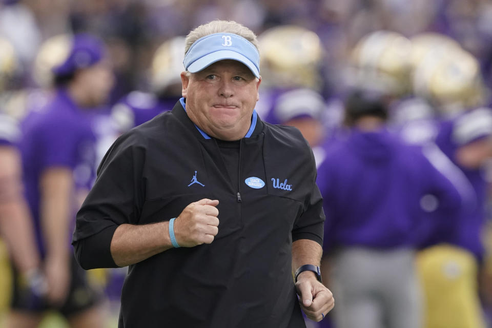 FILE - UCLA head coach Chip Kelly runs on the field before the team's NCAA college football game against Washington, Saturday, Oct. 16, 2021, in Seattle. Kelly’s arduous rebuilding job at UCLA started to show positive results last season with an 8-4 record and a Holiday Bowl invitation. (AP Photo/Ted S. Warren, File)