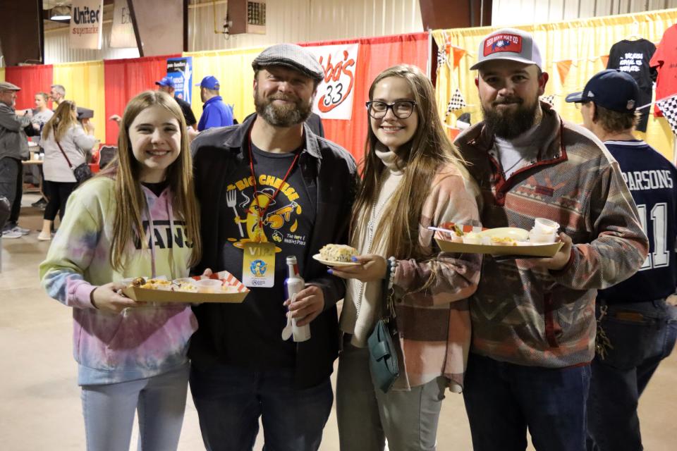 Clara Daigle, Trey Funderburg, Keely Daigle and Matt Donaghy try the many samples of macaroni and cheese at the Hope and Healing Place's annual The Big Cheese macaroni and cheese competition at the Rex Baxter Building Friday evening.