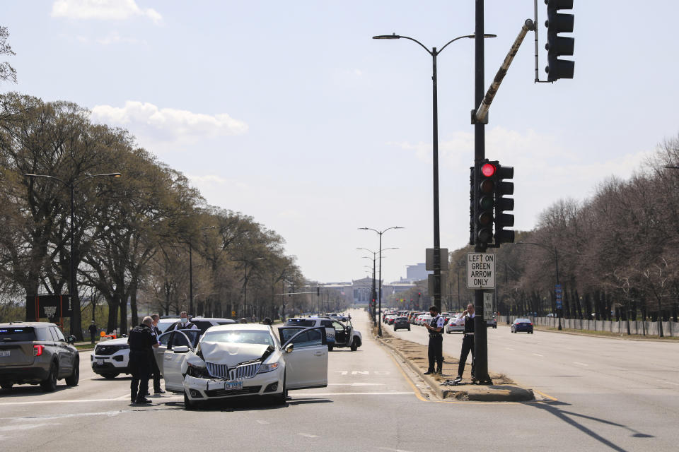 Chicago police investigate the scene of a shooting where a 2-year-old boy was shot in the head while he was traveling inside a car near Grant Park, Tuesday, April 6, 2021. (Jose M. Osorio/Chicago Tribune via AP)