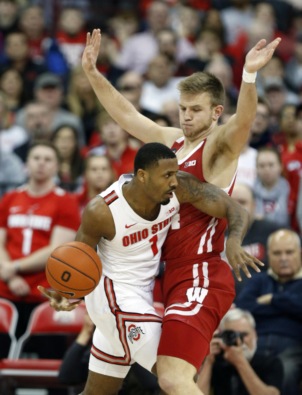 Ohio State guard Luther Muhammad, left, drives in front of Wisconsin guard Brad Davidson during the first half of an NCAA college basketball game in Columbus, Ohio, Friday, Jan. 3, 2020. (AP Photo/Paul Vernon)