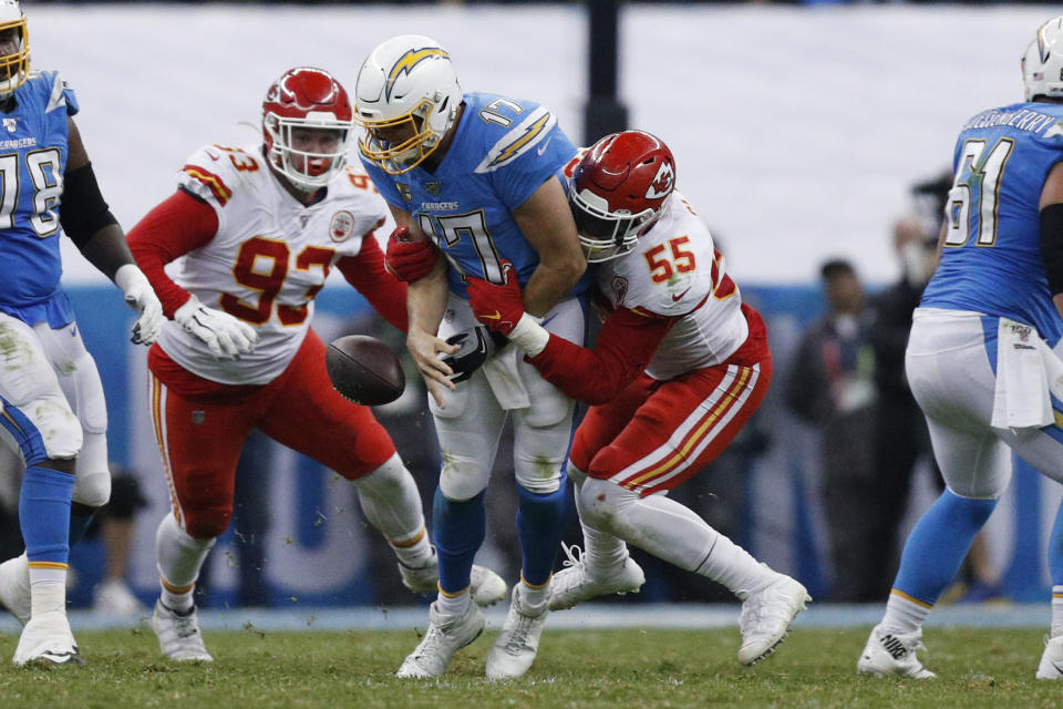 Los Angeles Chargers quarterback Philip Rivers, center, is sacked by Kansas City Chiefs defensive end Frank Clark (55) and defensive tackle Joey Ivie (93) during the second half of an NFL football game Monday, Nov. 18, 2019, in Mexico City. (AP Photo/Rebecca Blackwell)