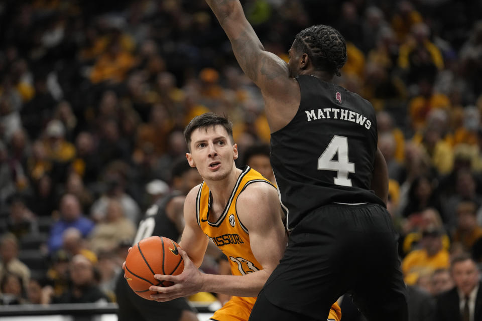 Missouri's Aidan Shaw (23) looks to the basket as Mississippi State's Cameron Matthews (4) defends during the second half of an NCAA college basketball game Saturday, Feb. 10, 2024, in Columbia, Mo. (AP Photo/Jeff Roberson)