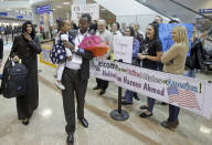 FILE - This Feb. 10, 2017, file photo, Abdisellam Hassen Ahmed, a Somali refugee who had been stuck in limbo after President Donald Trump temporarily banned refugee entries, walks with his wife Nimo Hashi, and his 2-year-old daughter, Taslim, who he met for the first time after arriving at Salt Lake City International Airport. President Trump appears to be ignoring a deadline to establish how many refugees will be allowed into the United States in 2021, raising uncertainty about the future of the 40-year-old resettlement program that has been dwindling under the administration. The 1980 Refugee Act requires presidents to issue their determination before Oct. 1, 2020, the start of the fiscal year. (AP Photo/Rick Bowmer, File)