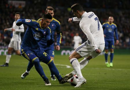 Football Soccer - Real Madrid v Celta Vigo - Spanish King's Cup - Santiago Bernabeu stadium, Madrid, Spain - 18/01/17 Real Madrid's Cristiano Ronaldo (R) and Celta Vigo's Facundo Roncaglia in action. REUTERS/Juan Medina