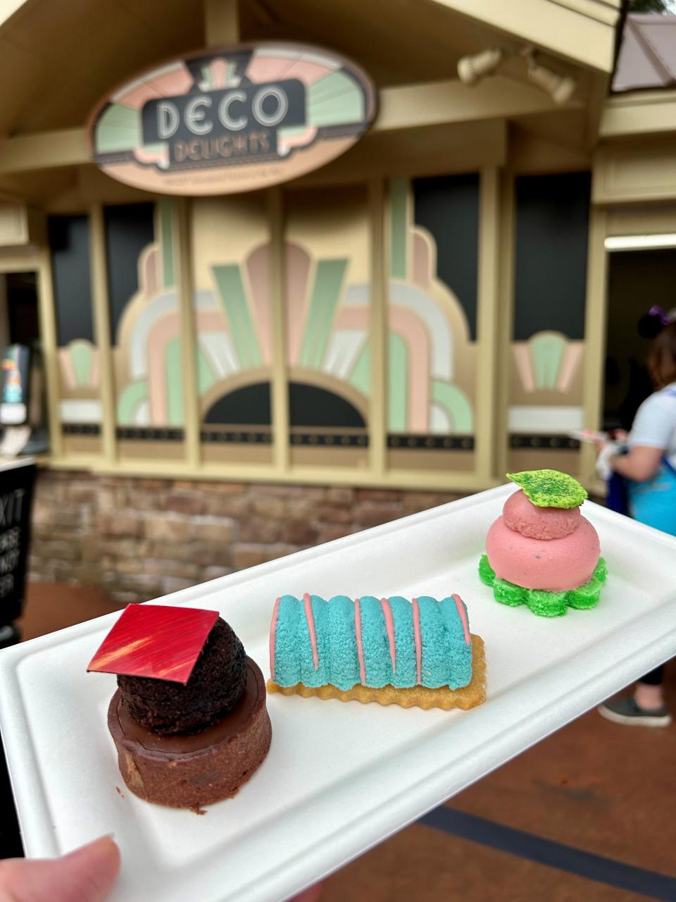 The Neapolitan Dessert Trio, which includes chocolate tart, vanilla bean cheesecake and strawberry mousse, is a new dish at the 2024 EPCOT International Festival of the Arts.