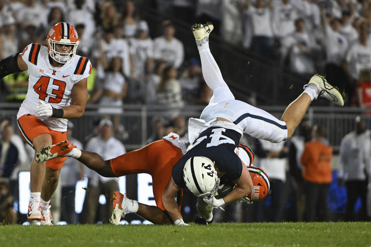 Penn State tight end Tyler Warren (44) is upended by Illinois defensive back Miles Scott (10) during the second quarter of an NCAA college football game, Saturday, Sept. 28, 2024, in State College, Pa. (AP Photo/Barry Reeger)