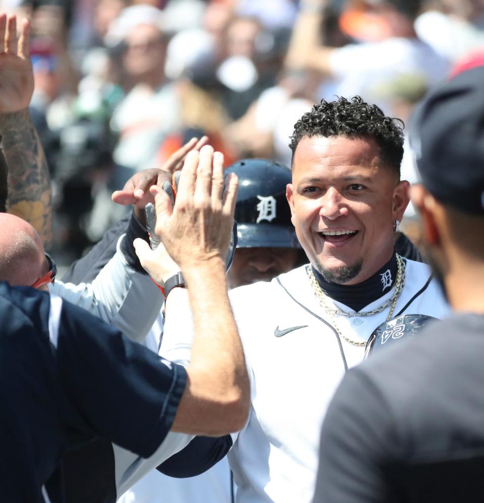 Detroit Tigers DH Miguel Cabrera high-fives teammates after scoring against the Colorado Rockies during the first inning Saturday, April 23, 2022 at Comerica Park.