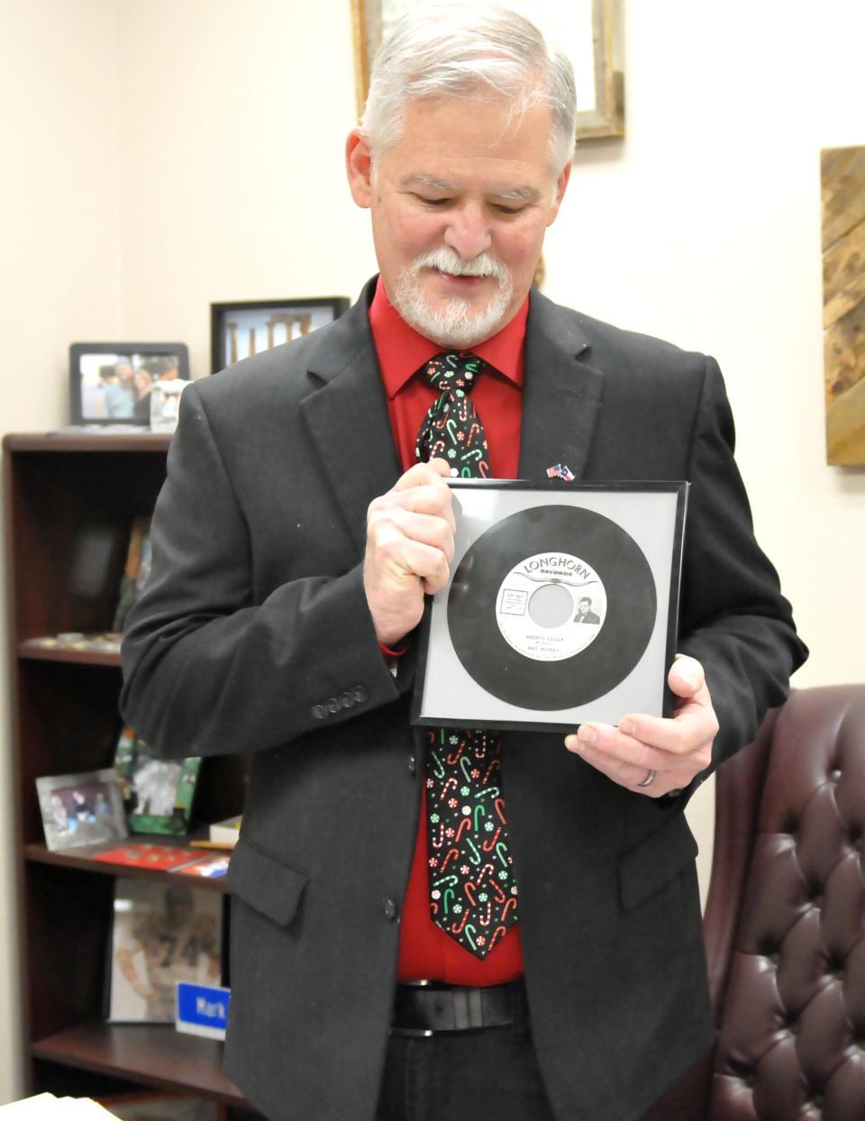 Wichita County Commissioner Mark Beauchamp displays a phonograph record inspired by a sheriff's war on shorts in 1951.