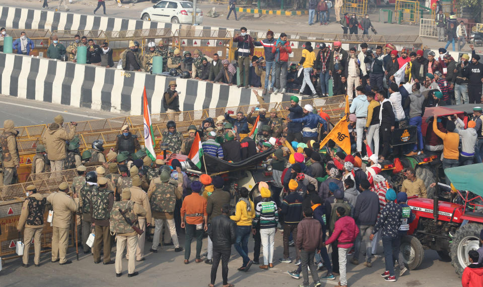 NOIDA, INDIA - JANUARY 26: Indian farmers on tractors remove police barricades during a rally as they continue their protest against the central government's recent agricultural reforms in Noida, India on January 26, 2021. (Photo by Pankaj Nangia/Anadolu Agency via Getty Images)