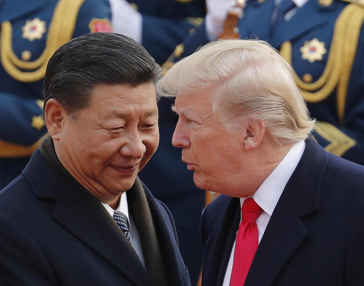 US President Donald Trump chats with Chinese President Xi Jinping during a welcome ceremony in Beijing on 9 November: AP