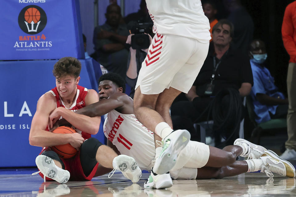 This photo provided by Bahamas Visual Services shows Wisconsin guard Carter Gilmore and Dayton guard Malachi Smnith (11) battle for the ball during an NCAA college basketball game at the Battle 4 Atlantis at Paradise Island, Bahamas, Wednesday, Nov. 23, 2022. . (Tim Aylen/Bahamas Visual Services via AP)