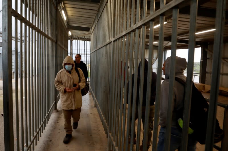 Palestinians working in Israel head to work through an Israeli checkpoint near Ramallah in the Israeli-occupied West Bank