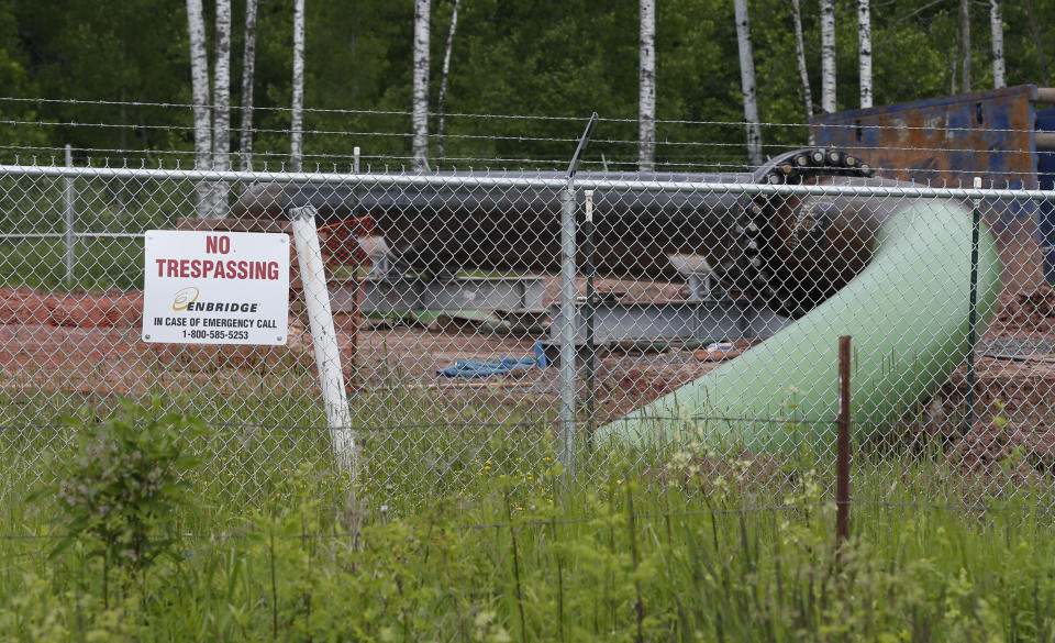 FILE - In this June 29, 2018 file photo, a No Trespassing sign is visible at a Enbridge Energy pipeline drilling pad along a rail line that traces the Minnesota-Wisconsin border south of Jay Cooke State Park in Minnesota. After President Joe Biden revoked Keystone XL's presidential permit and shut down construction of the long-disputed pipeline that was to carry oil from Canada to Texas, opponents of other pipelines hoped the projects they've been fighting would be next. (AP Photo/Jim Mone File)