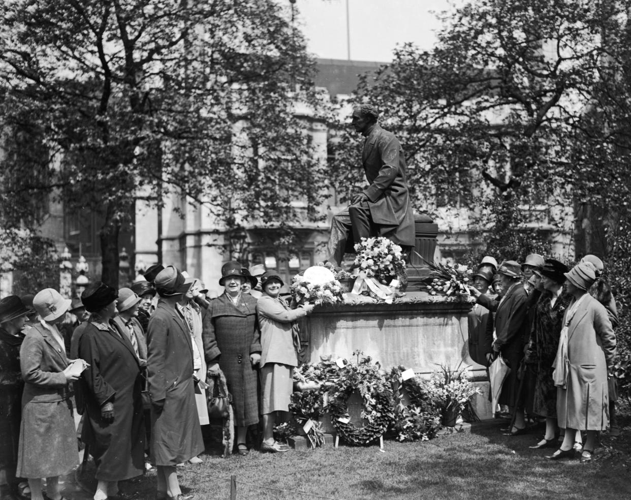 Representatives of the Women’s Freedom League make a 1928 pilgrimage to the statue of English philosopher John Stuart Mill (1806 – 1873) at Temple Gardens, London. (Credit: London Express/Getty Images)