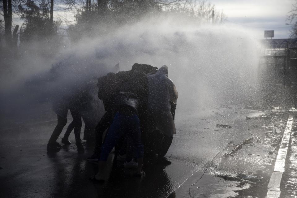 A Greek police water cannon operates from Kastanies border gate as migrants try to enter Greece from the Pazarkule border gate, Turkey at the Turkish-Greek border on Friday, March 6, 2020. Clashes erupted anew on the Greek-Turkish border Friday as migrants attempted to push through into Greece, while the European Union's foreign ministers held an emergency meeting to discuss the situation on the border and in Syria, where Turkish troops are fighting. (AP Photo)