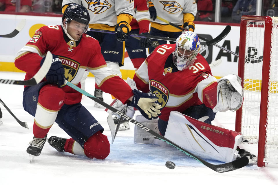 Florida Panthers forward Steven Lorentz (18) and goalie Spencer Knight defend the goal during the first period of a preseason NHL hockey game against the Nashville Predators, Monday, Sept. 25, 2023, in Sunrise, Fla. (AP Photo/Lynne Sladky)