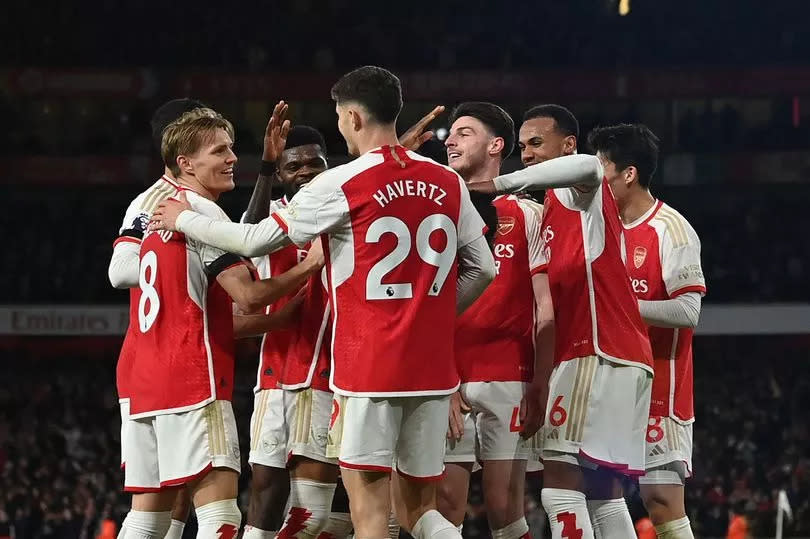 Arsenal's English defender #04 Ben White celebrates with teammates after scoring their fifth goal during the English Premier League football match between Arsenal and Chelsea at the Emirates Stadium in London on April 23, 2024.