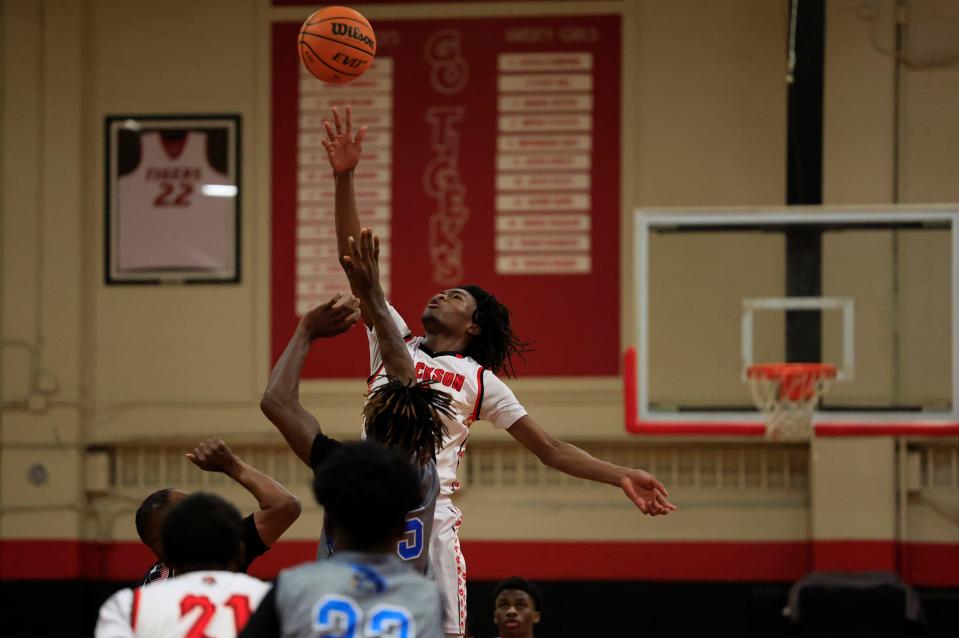 Jackson and Ribault players leap for the opening tip-off in the District 3-4A final on Feb. 10. The Northside schools compete again in Tuesday's regional semifinal.