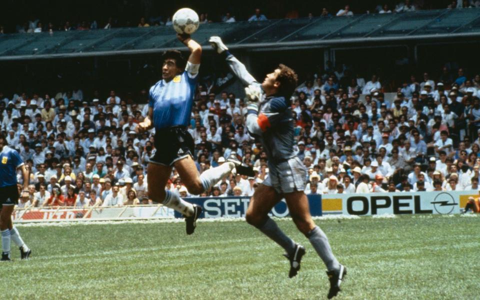 Argentina's Diego Maradona scores a goal with his Hand of God, past England goalkeeper Peter Shilton in the 1986 World Cup quarter-final