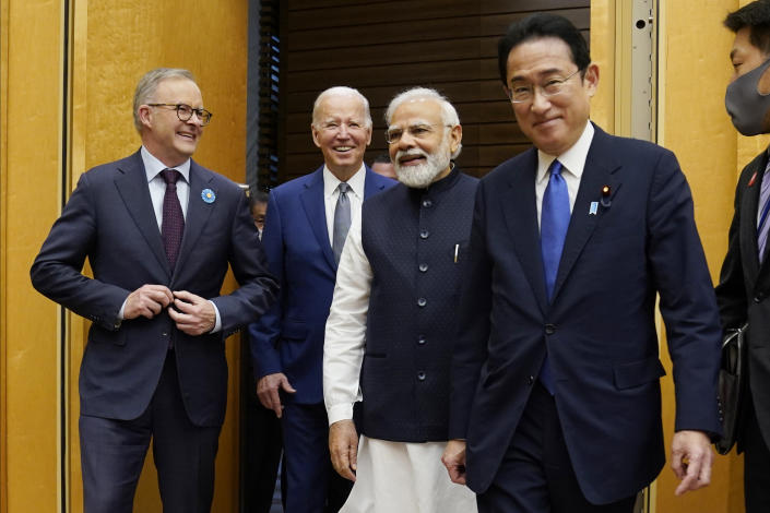 FILE - From left, Australian Prime Minister Anthony Albanese, U.S. President Joe Biden and Indian Prime Minister Narendra Modi are greeted by Japanese Prime Minister Fumio Kishida, right, during their arrival to the Quad leaders summit at Kantei Palace, May 24, 2022, in Tokyo. Biden has an ambitious agenda when he sets off later this week on an eight-day trip to the Indo-Pacific. For part of his trip Biden will travel to Australia for a summit with fellow Quad leaders. (AP Photo/Evan Vucci, File)