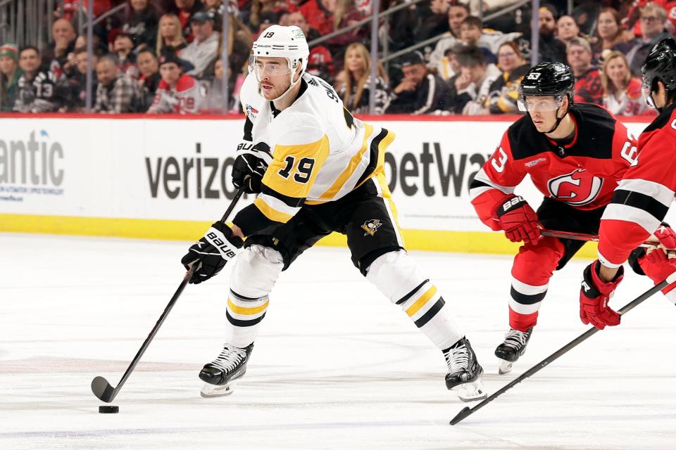 NEWARK, NJ - APRIL 2: Reilly Smith #19 of the Pittsburgh Penguins controls the puck past Jesper Bratt #63 of the New Jersey Devils during the third period at the Prudential Center on April 2, 2024 in Newark, New Jersey. The Penguins won 6-3.