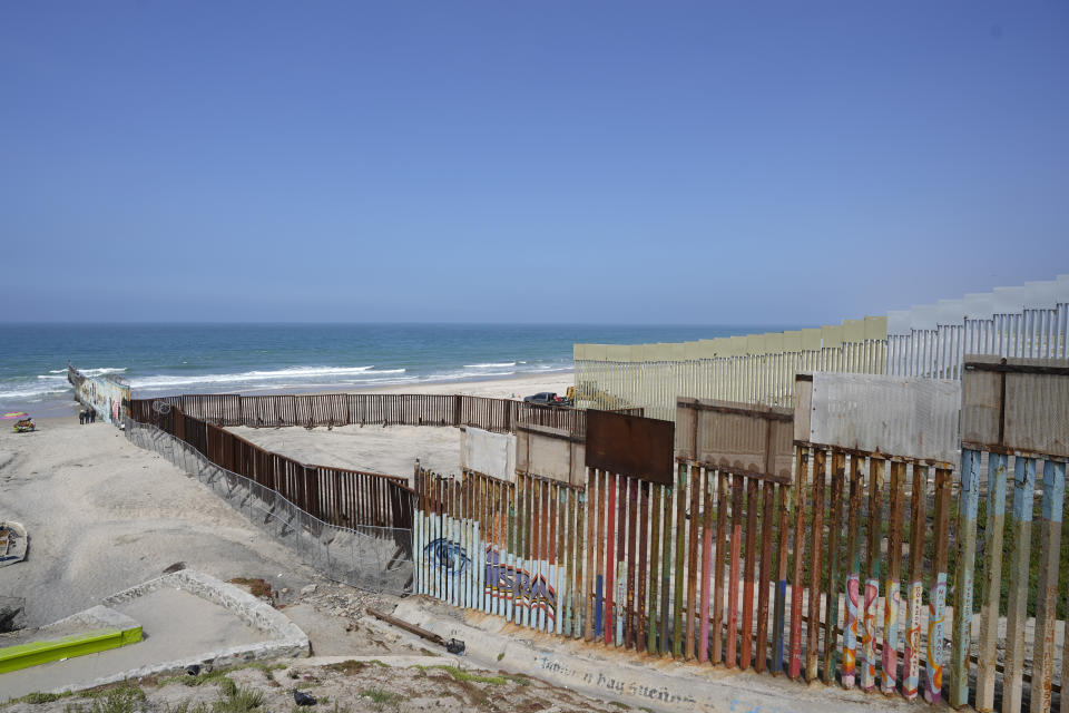 FILE - Construction continues on the border wall that separate the United States from Mexico, as seen from Tijuana, Mexico, Aug. 25, 2023. Construction of the wall along the U.S.-Mexico border under former President Donald Trump toppled untold numbers of saguaro cactuses in Arizona, put endangered ocelots at risk in Texas and disturbed Native American burial grounds, Congress' official watchdog said Thursday, Sept. 7. (AP Photo/Gregory Bull, File)