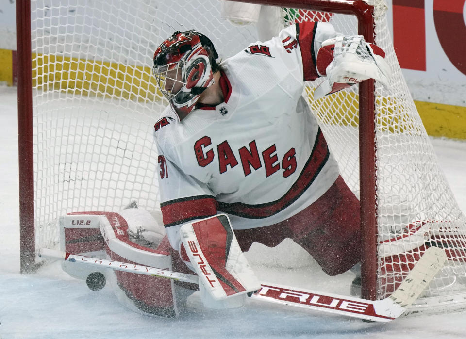 Carolina Hurricanes goaltender Frederik Andersen makes a pad-save during overtime NHL hockey game action against the Ottawa Senators, Thursday, Jan. 27, 2022, in Ottawa, Ontario. (Adrian Wyld/The Canadian Press via AP)