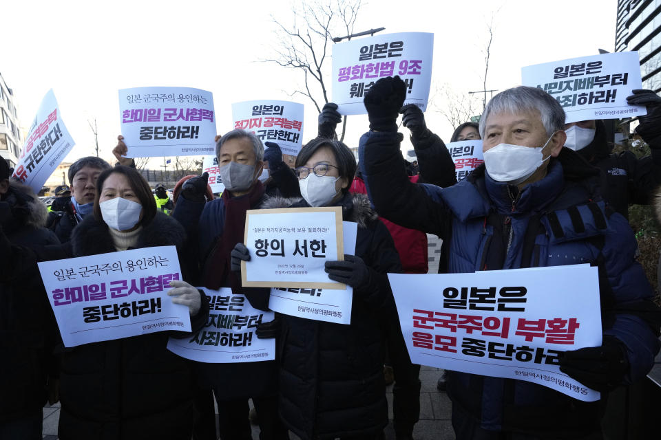 Protesters shout slogans during a rally to oppose Japan's adoption of a new national security strategy near the Japanese Embassy in Seoul, South Korea, Tuesday, Dec. 20, 2022. North Korea threatened Tuesday to take "bold and decisive military steps" against Japan as it slammed Tokyo's adoption of a national security strategy as an attempt to turn the country into an aggressive military power. The banners read "Stop military cooperation between South Korea, the U.S. and Japan military alliance." (AP Photo/Ahn Young-joon)