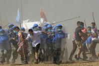 United Nations troop break up fighting in a scenario where participants playing the role of civilians fighting over water resource during the Shared Destiny 2021 drill at the Queshan Peacekeeping Operation training base in Queshan County in central China's Henan province Wednesday, Sept. 15, 2021. Peacekeeping troops from China, Thailand, Mongolia and Pakistan took part in the 10 days long exercise that field reconnaissance, armed escort, response to terrorist attacks, medical evacuation and epidemic control. (AP Photo/Ng Han Guan)